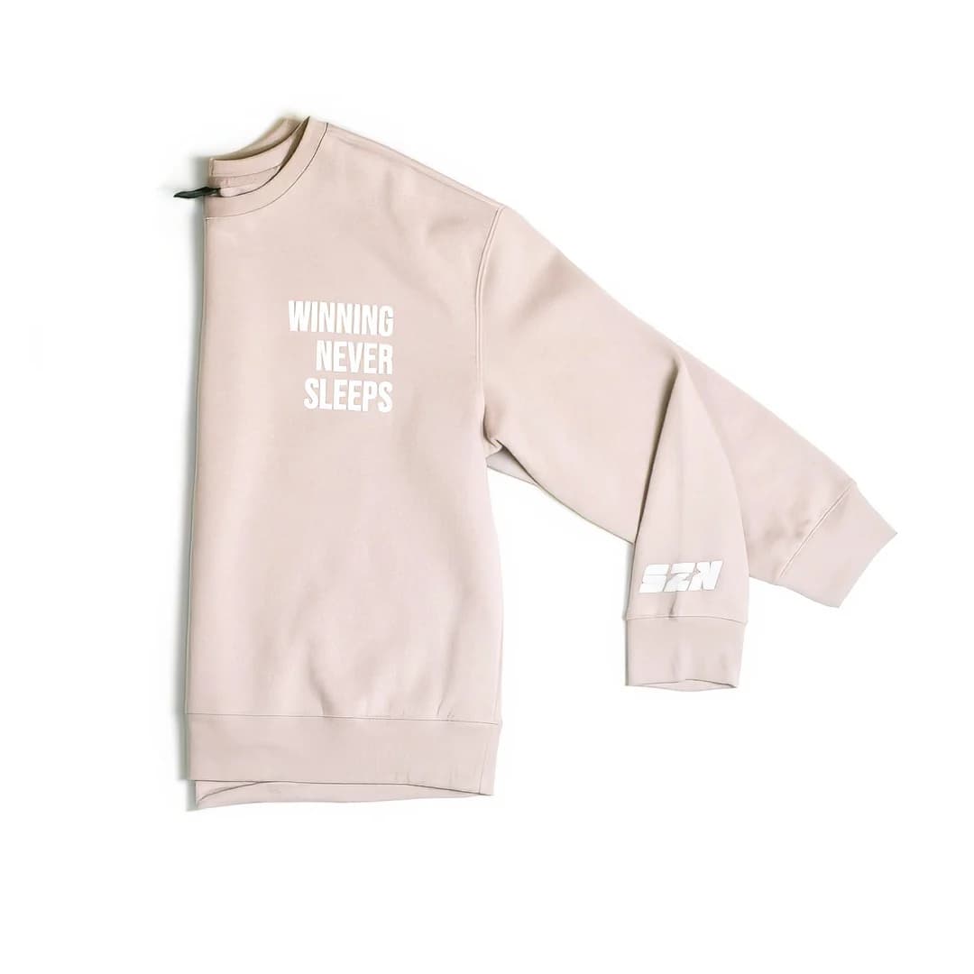 Sand Winning Never Sleeps crewneck with the sleeve visible